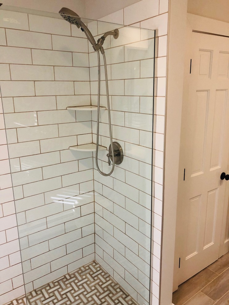 Country bathroom in Bridgeport with white tile and ceramic tile.