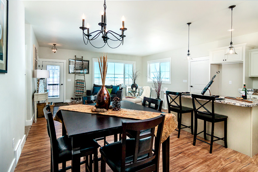 Open concept kitchen - mid-sized transitional l-shaped medium tone wood floor open concept kitchen idea with an undermount sink, recessed-panel cabinets, white cabinets, granite countertops, stainless steel appliances and an island