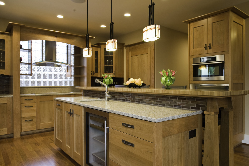 Photo of a traditional kitchen in Seattle with glass-front cabinets and slate splashback.