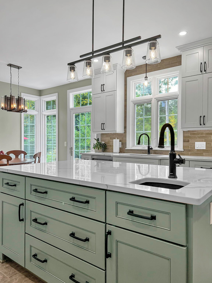Mid-sized contemporary kitchen in New York with an undermount sink, shaker cabinets, green cabinets, quartz benchtops, green splashback, porcelain splashback, stainless steel appliances, vinyl floors, with island and white benchtop.