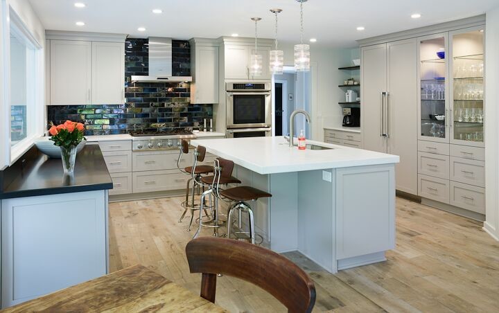 Transitional ceramic tile kitchen photo in Cleveland with a single-bowl sink, recessed-panel cabinets, gray cabinets, quartz countertops, metallic backsplash, cement tile backsplash, white appliances and an island