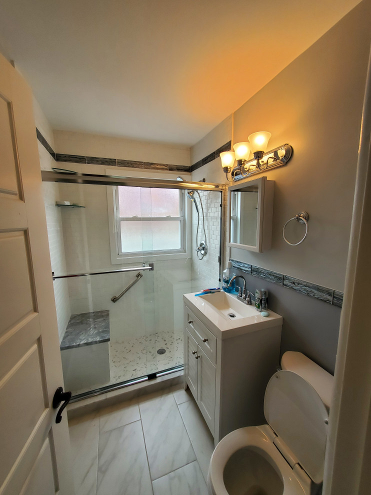Small modern master bathroom in Philadelphia with shaker cabinets, white cabinets, white tile, ceramic tile, cement tiles, marble benchtops, a sliding shower screen, white benchtops, a single vanity and a freestanding vanity.