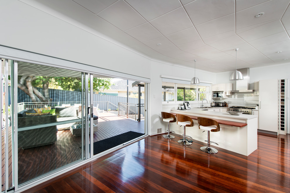 Design ideas for a mid-sized modern eat-in kitchen in Perth with white splashback, dark hardwood floors and no island.