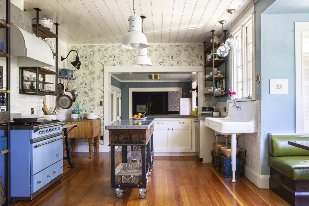 Inspiration for an eclectic eat-in kitchen in Portland with a farmhouse sink, white splashback, ceramic splashback, coloured appliances, multiple islands and wood.
