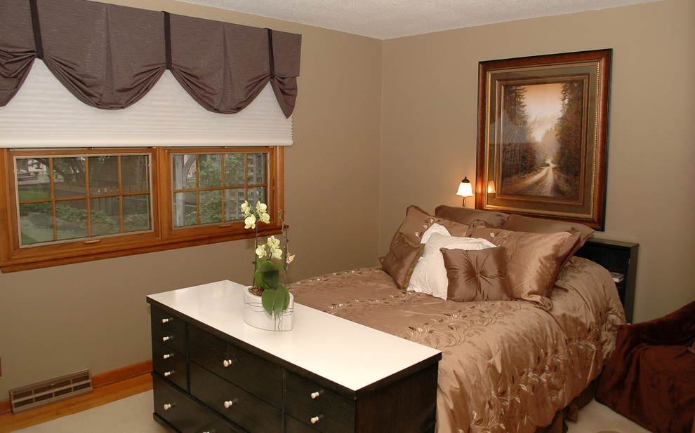 This is an example of a large traditional master bedroom in Other with beige walls, carpet and no fireplace.