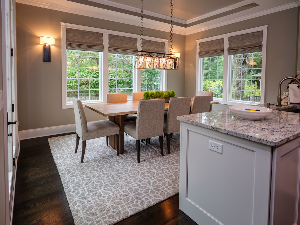 Mid-sized transitional kitchen/dining combo in Chicago with grey walls, dark hardwood floors, no fireplace and brown floor.