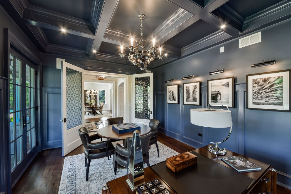 Large transitional study room in Chicago with blue walls, dark hardwood floors, no fireplace, a freestanding desk, coffered and decorative wall panelling.