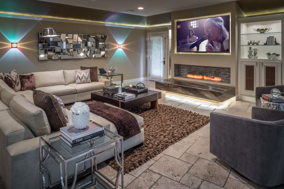 This is an example of a large transitional open concept family room in Houston with a game room, beige walls, travertine floors, a ribbon fireplace, a wall-mounted tv and a plaster fireplace surround.