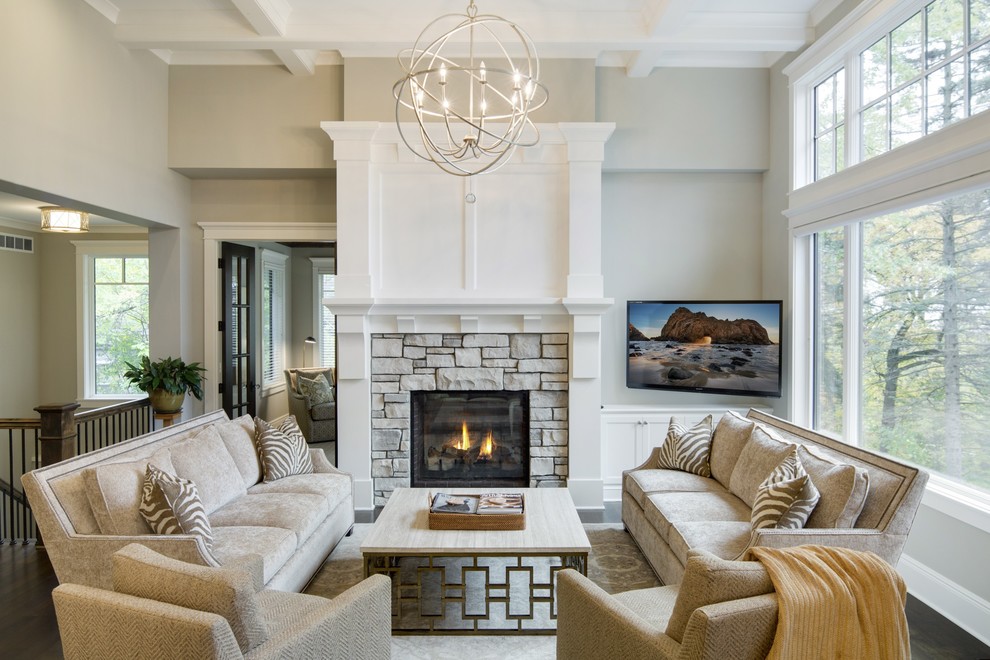 Design ideas for a transitional open concept living room in Minneapolis with a standard fireplace, a wall-mounted tv, beige walls and a stone fireplace surround.