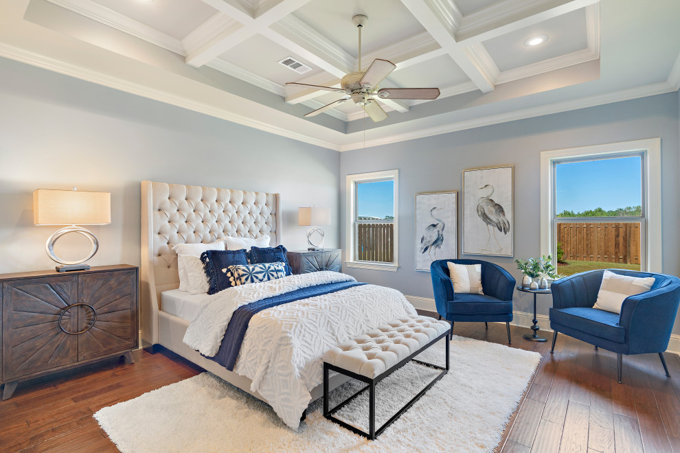 Photo of a large transitional master bedroom in New Orleans with grey walls, medium hardwood floors and brown floor.