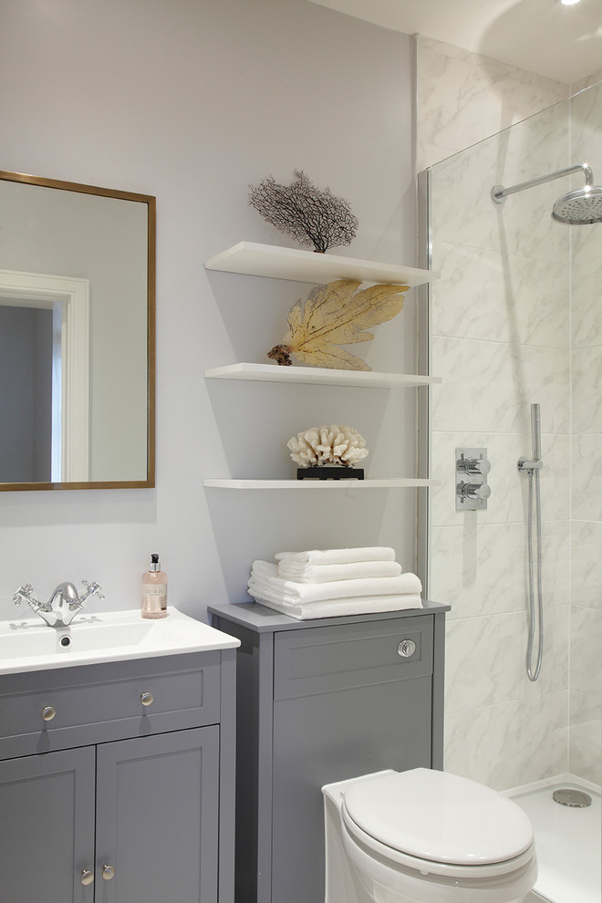 Photo of a small traditional 3/4 bathroom in London with recessed-panel cabinets, grey cabinets, an open shower, marble, grey walls, marble floors, an integrated sink and a hinged shower door.