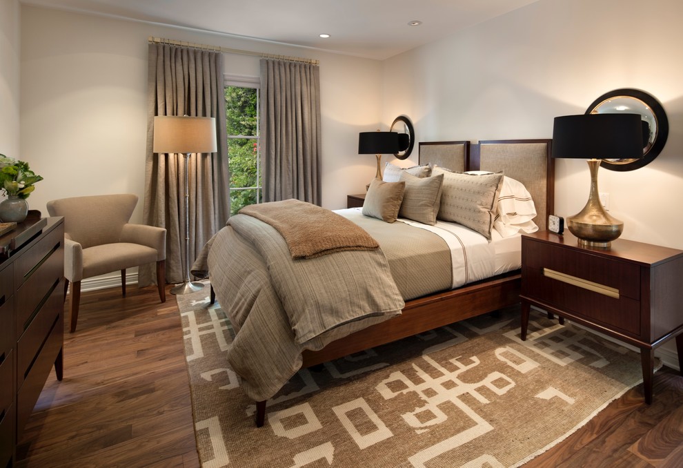 This is an example of a mid-sized transitional guest bedroom in Los Angeles with dark hardwood floors, beige walls, no fireplace and brown floor.