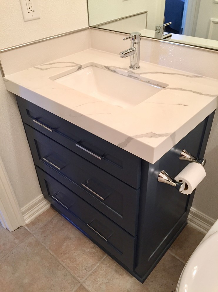 This is an example of a small transitional 3/4 bathroom in Dallas with recessed-panel cabinets, white cabinets, a corner shower, a one-piece toilet, blue tile, blue walls, porcelain floors, an undermount sink, marble benchtops, beige floor and a hinged shower door.