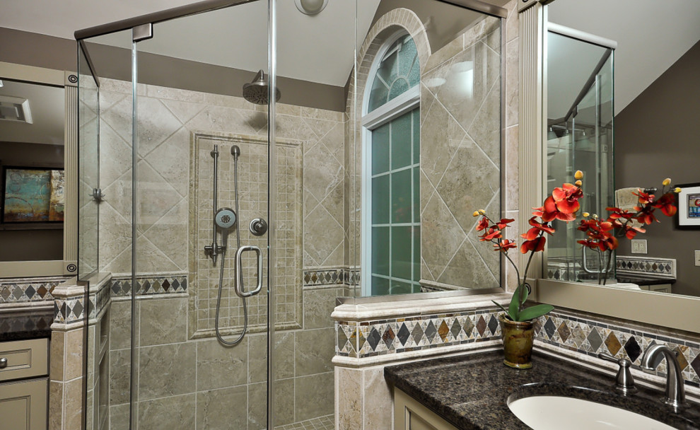 Corner shower - large transitional master gray tile corner shower idea with recessed-panel cabinets, white cabinets, an undermount sink and a hinged shower door