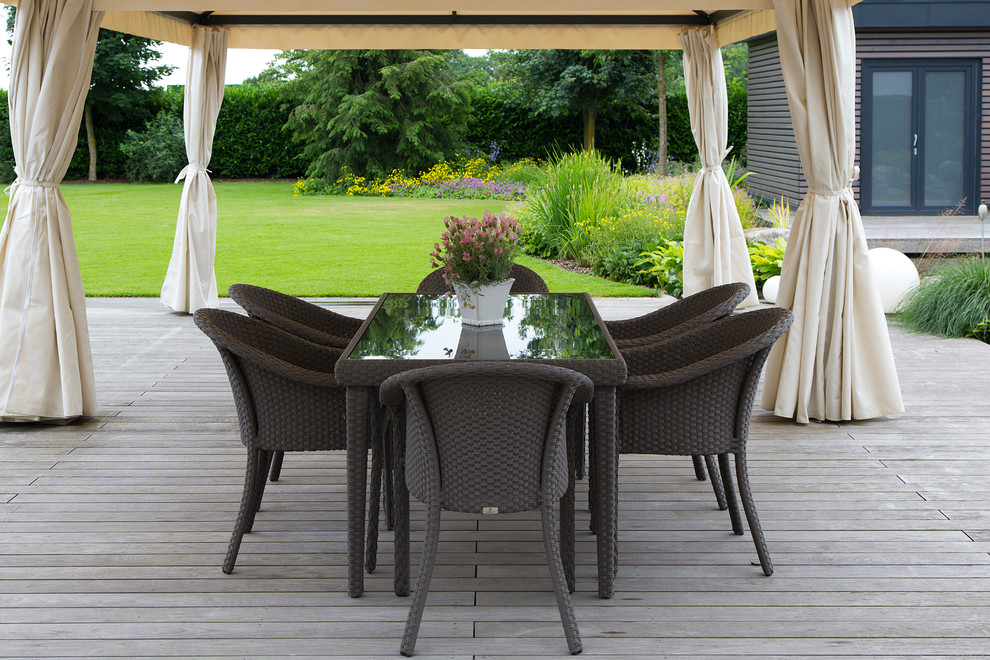 Inspiration for a large traditional backyard deck in Other with an awning.