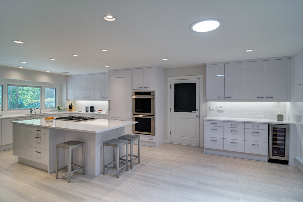This is an example of a contemporary separate kitchen in Atlanta with white cabinets and with island.