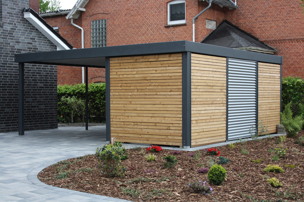 This is an example of a mid-sized contemporary detached one-car carport in Bremen.