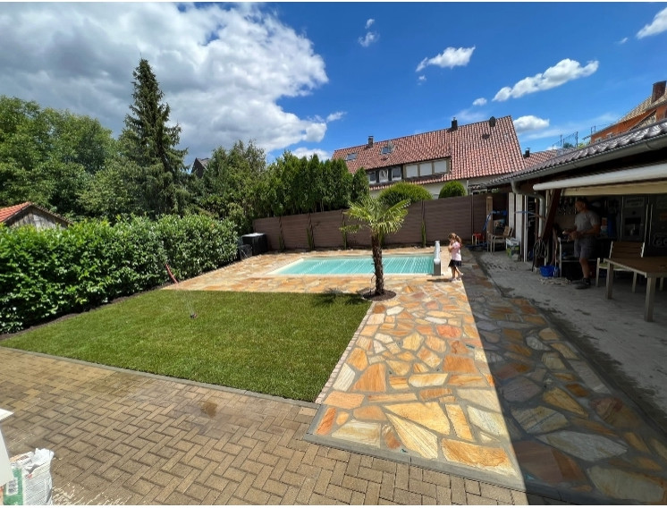Mittelgroßer Mediterraner Pool hinter dem Haus in rechteckiger Form mit Natursteinplatten in Düsseldorf