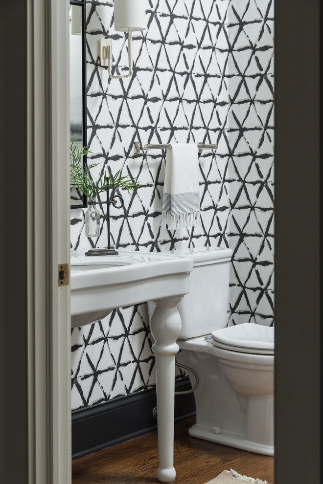 Example of a mid-sized transitional medium tone wood floor and brown floor bathroom design in Chicago with furniture-like cabinets, white cabinets and black walls