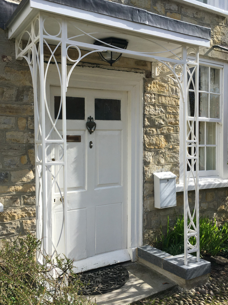 Inspiration for a small rural front door in Devon with a single front door and a white front door.