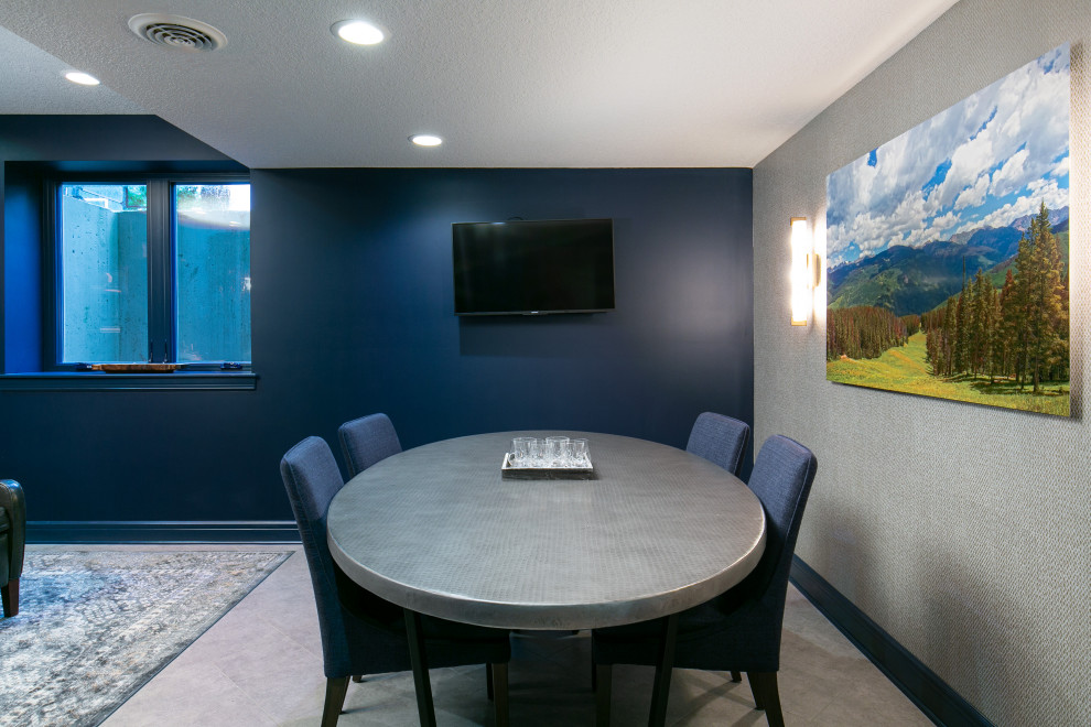 Mid-sized fully buried basement in Kansas City with a game room, blue walls, vinyl floors and wallpaper.