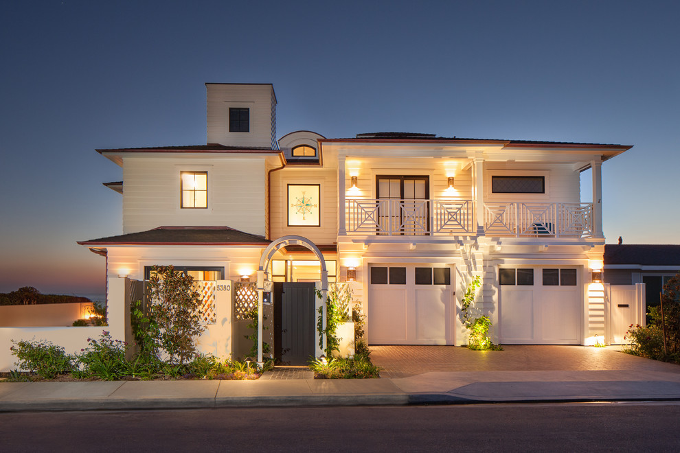 Photo of a beach style two-storey white exterior in San Diego with wood siding.
