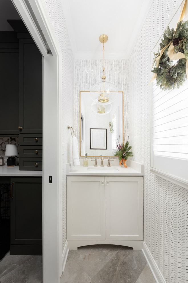 Design ideas for a small classic cloakroom in Chicago with flat-panel cabinets, white cabinets, a one-piece toilet, porcelain flooring, a submerged sink, engineered stone worktops, beige floors, white worktops, a built in vanity unit and wallpapered walls.