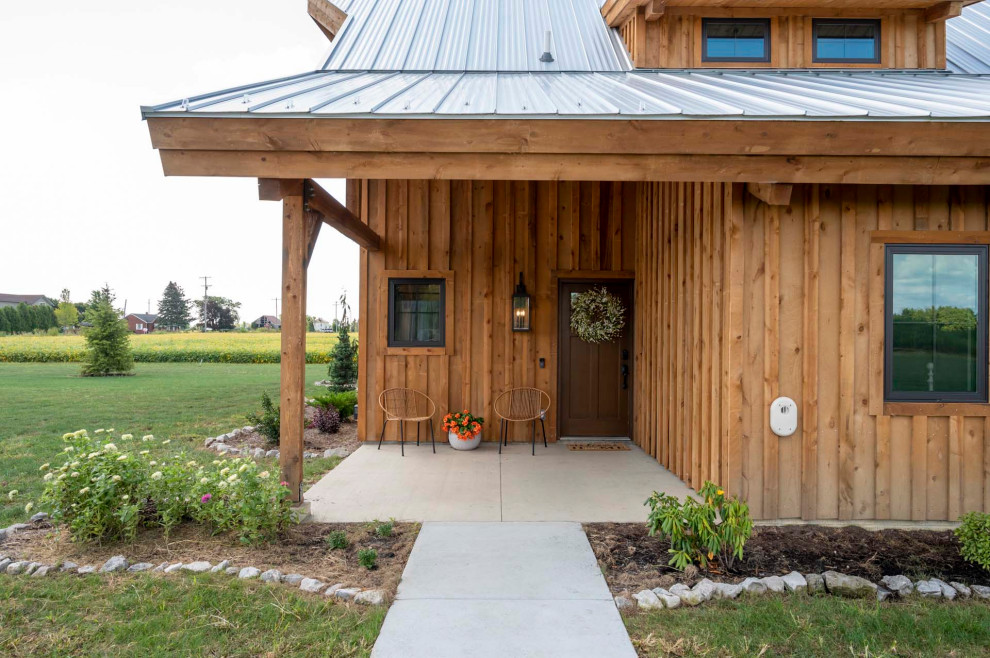 Inspiration for a mid-sized rustic front door remodel with a brown front door