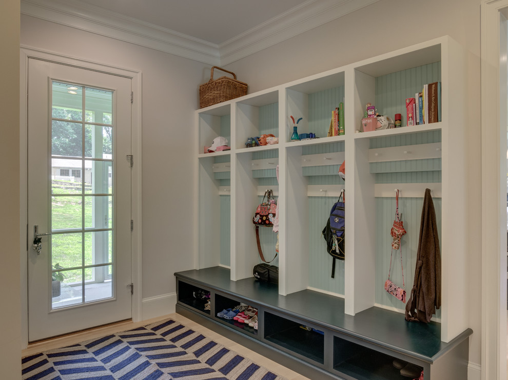 Photo of a mid-sized mudroom in Other with white walls, carpet, a single front door and a white front door.