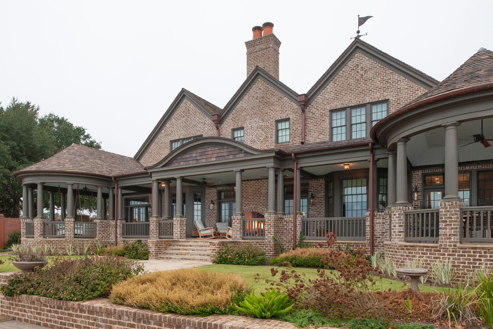 Photo of a traditional two-storey brick house exterior in Houston with a gable roof.