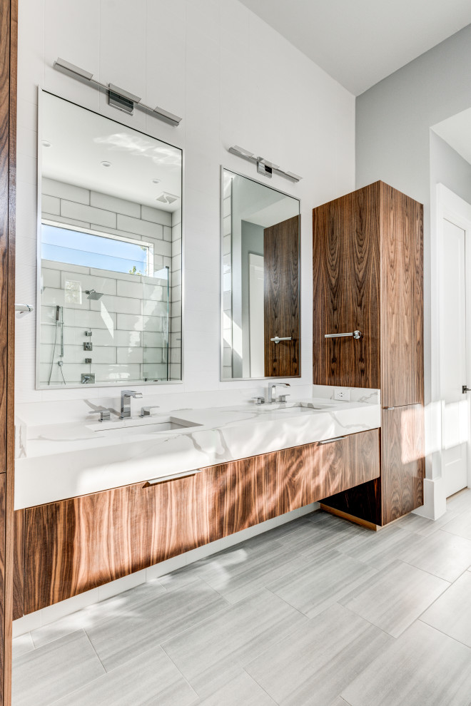 Double shower - transitional master white tile and porcelain tile porcelain tile and gray floor double shower idea in Dallas with flat-panel cabinets, medium tone wood cabinets, a one-piece toilet, white walls, an undermount sink, quartz countertops and white countertops