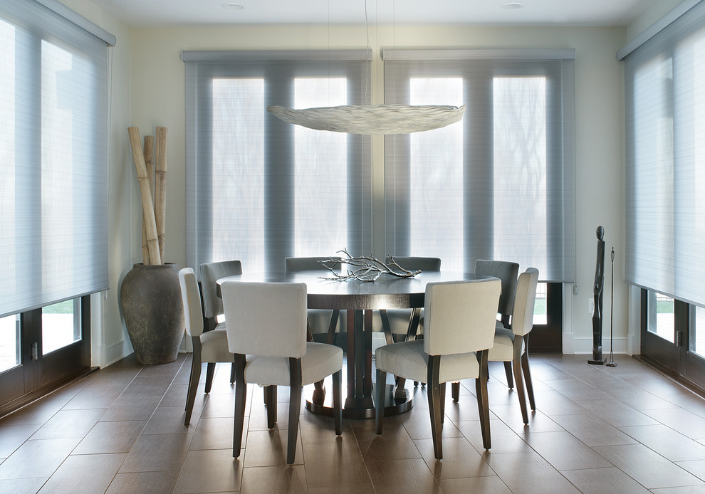 Inspiration for a mid-sized modern kitchen/dining combo in New York with white walls, porcelain floors and no fireplace.