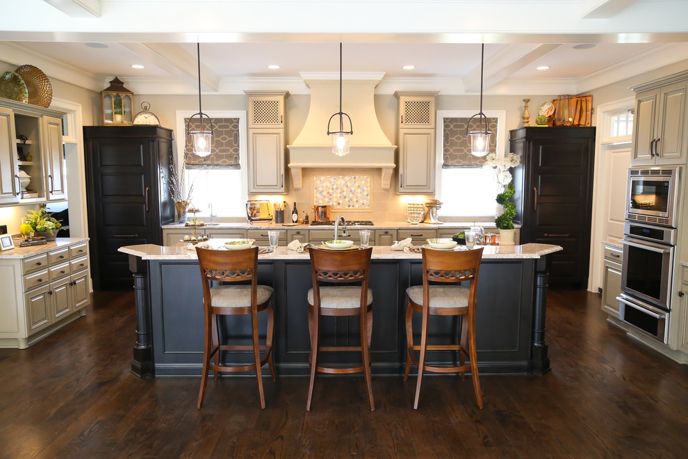 Inspiration for a mid-sized transitional single-wall eat-in kitchen in Indianapolis with raised-panel cabinets, grey cabinets, granite benchtops, beige splashback, panelled appliances, with island, an undermount sink, ceramic splashback and dark hardwood floors.