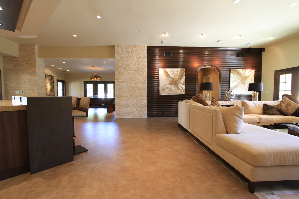 Photo of a large contemporary open concept family room in Orange County with porcelain floors, beige walls and no fireplace.