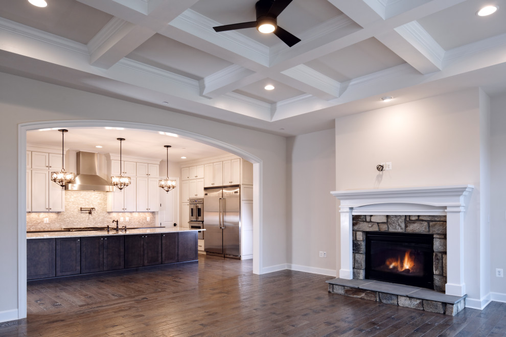 Inspiration for a mid-sized traditional open concept family room in Baltimore with a standard fireplace, a brick fireplace surround, brown floor, coffered, white walls and a wall-mounted tv.