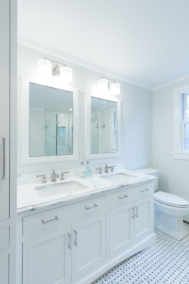 Inspiration for a mid-sized traditional master bathroom in Boston with shaker cabinets, white cabinets, an undermount tub, a corner shower, a two-piece toilet, white tile, marble, grey walls, marble floors, an undermount sink, marble benchtops, white floor, a hinged shower door and white benchtops.