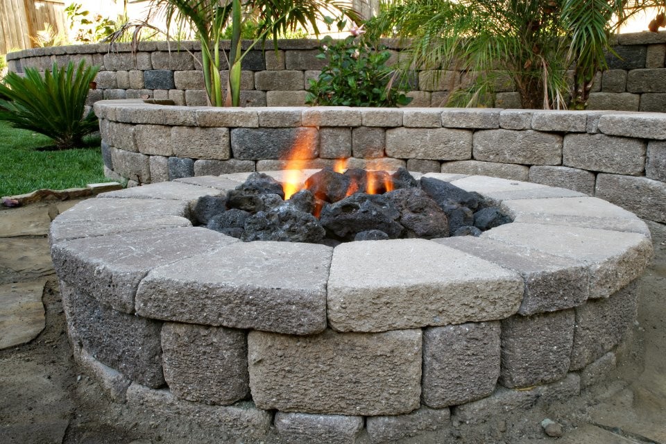 Design ideas for an arts and crafts backyard patio in Orange County with a fire feature and brick pavers.
