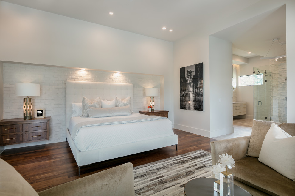 This is an example of a mid-sized modern master bedroom with white walls, dark hardwood floors and brown floor.