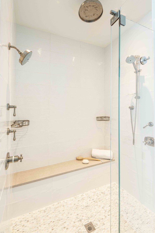 Mid-sized beach style master bathroom in DC Metro with beaded inset cabinets, blue cabinets, an alcove shower, a two-piece toilet, multi-coloured tile, matchstick tile, white walls, limestone floors, an undermount sink, limestone benchtops, grey floor, a hinged shower door and grey benchtops.