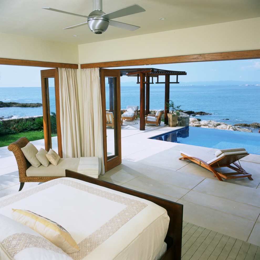 Large island style master bedroom photo in Other with beige walls