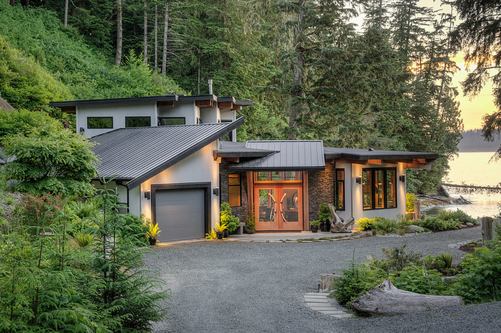 Inspiration for a contemporary two-storey exterior in Vancouver with metal siding and a shed roof.