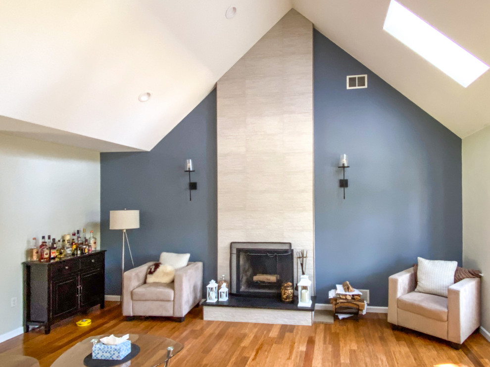 Inspiration for an expansive contemporary living room in Bridgeport with grey walls, bamboo floors, a standard fireplace, a tile fireplace surround, brown floor and vaulted.