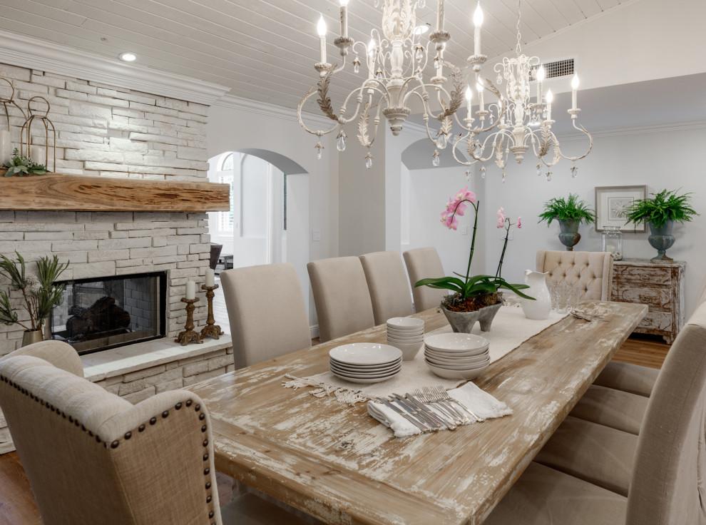 Design ideas for a large rural open plan dining room in Miami with white walls, a two-sided fireplace, a stacked stone fireplace surround and a wood ceiling.