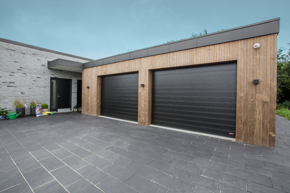 This is an example of an expansive scandinavian attached two-car garage in Aalborg.
