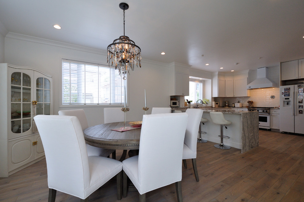 Photo of a traditional open plan dining in Other with white walls, painted wood floors and grey floor.