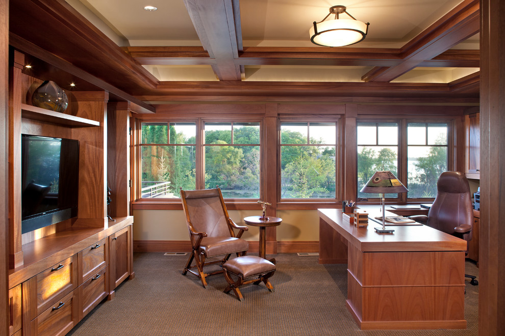 This is an example of an arts and crafts study room in Minneapolis with beige walls, carpet and a freestanding desk.