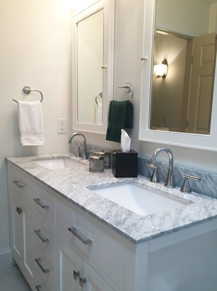 Inspiration for a mid-sized transitional gray tile and porcelain tile porcelain tile home design remodel in Indianapolis with flat-panel cabinets, white cabinets, a one-piece toilet, white walls, an undermount sink and marble countertops