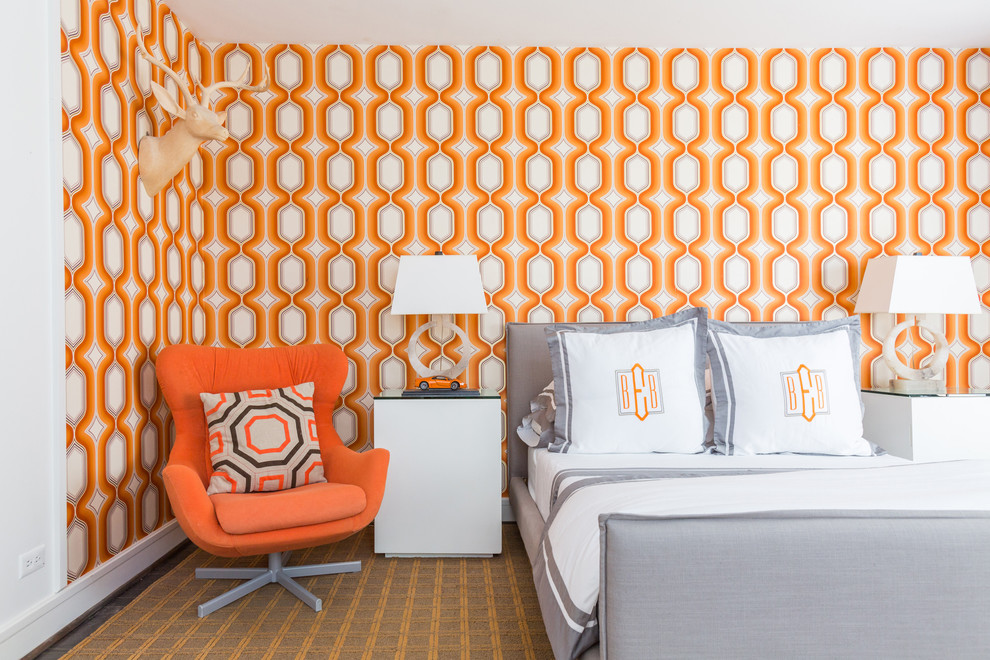 Photo of a transitional bedroom in Houston with orange walls.