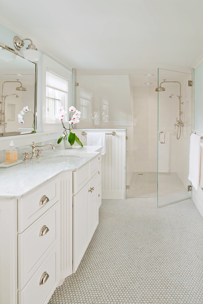 Large traditional master bathroom in Providence with an undermount sink, recessed-panel cabinets, white cabinets, white tile, mosaic tile floors, an alcove tub, a curbless shower, subway tile, blue walls, marble benchtops, white floor, a hinged shower door and white benchtops.