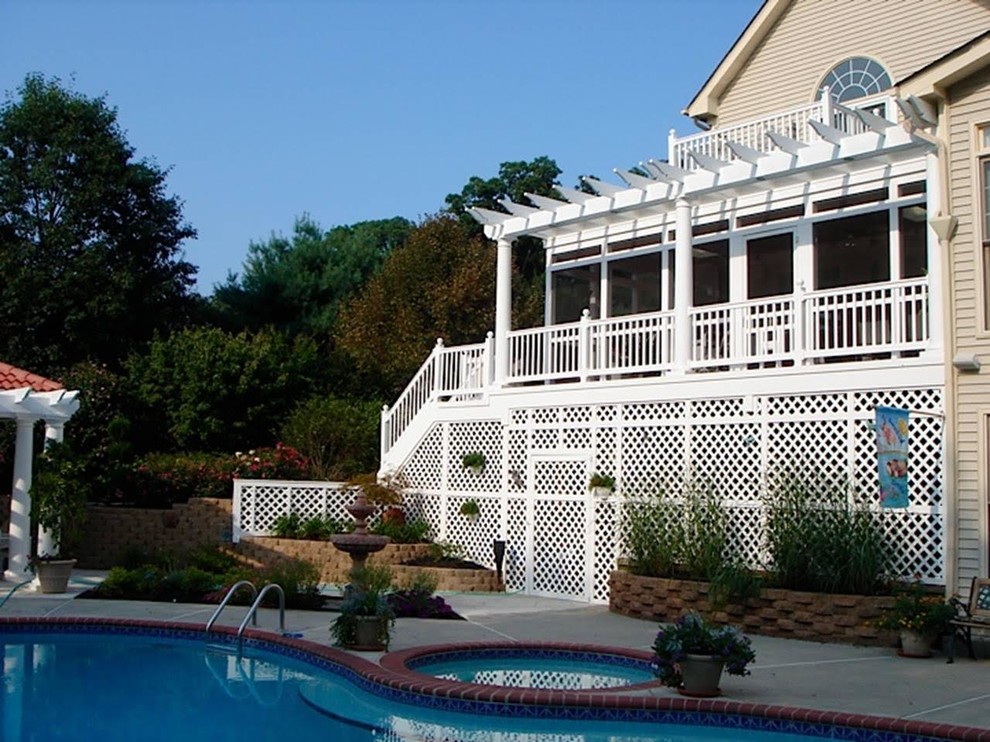 Example of a mid-sized transitional backyard deck design in DC Metro with a pergola
